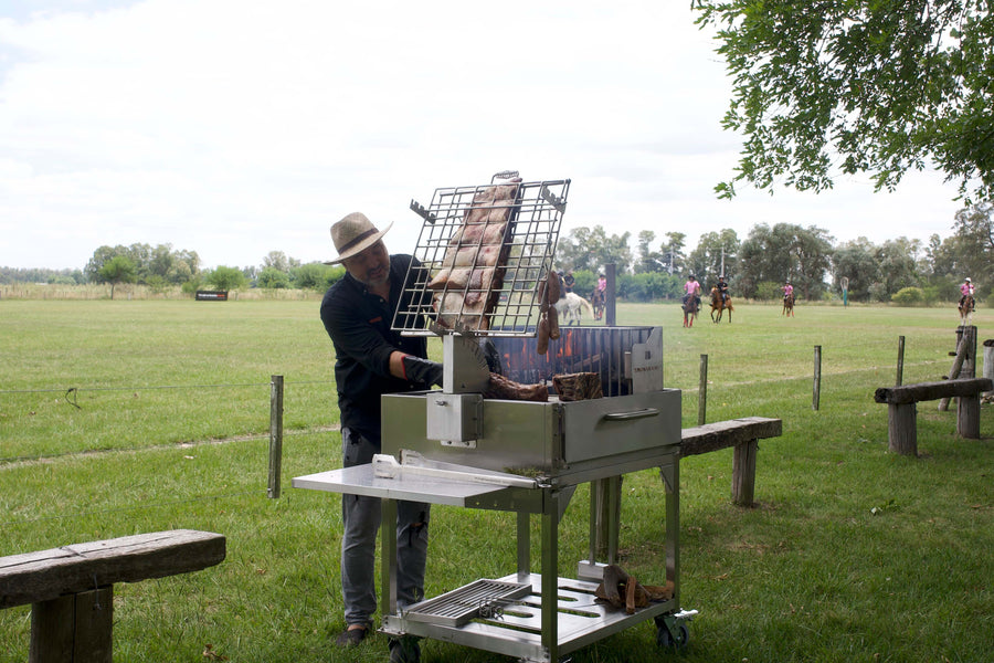 The asador manages the entire cooking process and occupies a respected role traditionally learned through observation and practice.